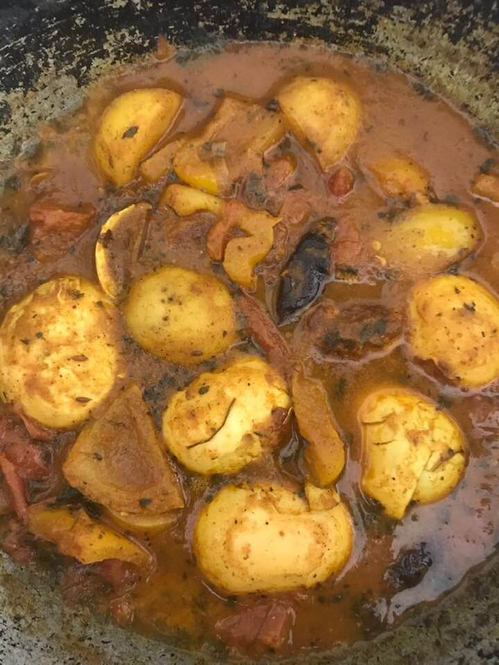 A bowl of egg curry with indian spices and cooked vegetables